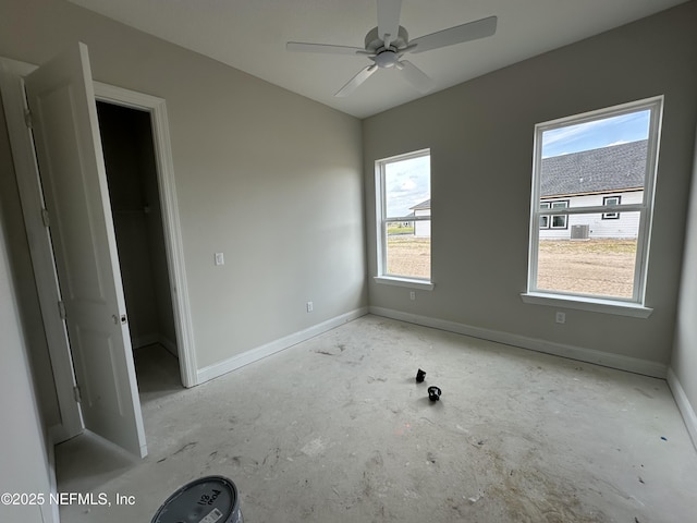 unfurnished bedroom featuring a walk in closet, ceiling fan, and a closet