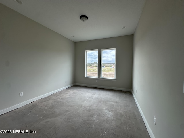 spare room with concrete flooring