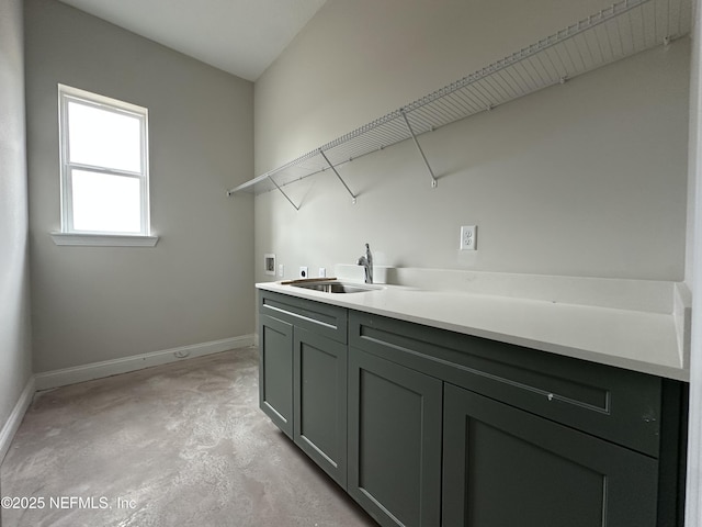 laundry room with electric dryer hookup, hookup for a washing machine, cabinets, and sink