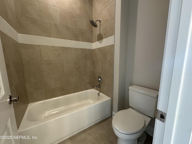 bathroom featuring tub / shower combination, toilet, and tile patterned floors