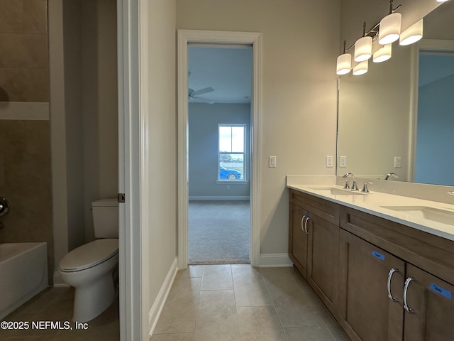 full bath featuring toilet, ceiling fan, a sink, and tile patterned floors