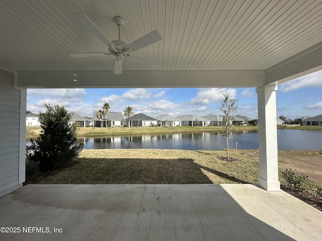 view of patio featuring ceiling fan, a water view, and a residential view