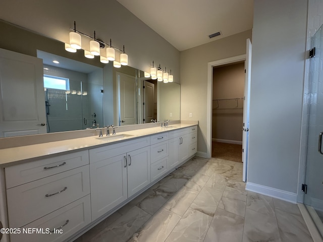 full bathroom featuring marble finish floor, a shower stall, visible vents, and a sink