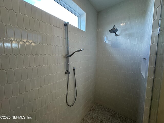 bathroom with tiled shower