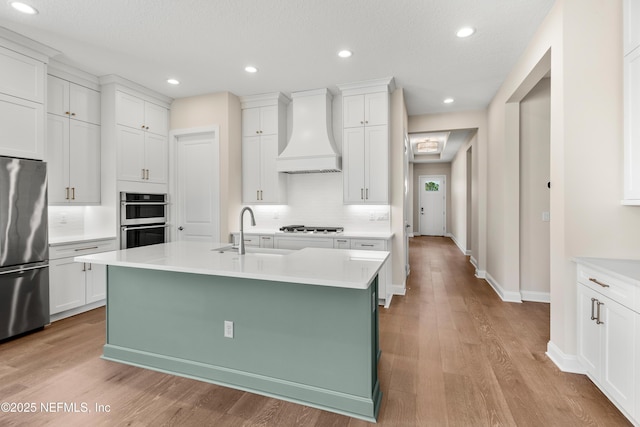 335 Lamego Ln, Saint Augustine, FL 32095 - kitchen with custom exhaust hood, stainless steel appliances, a sink, and light countertops