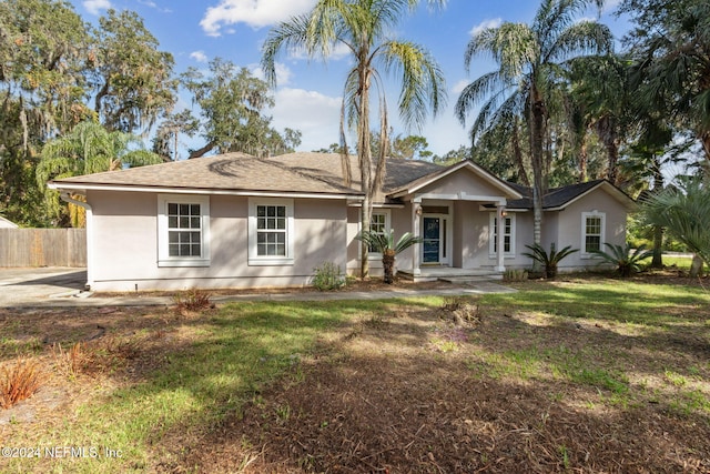 ranch-style home featuring a front yard