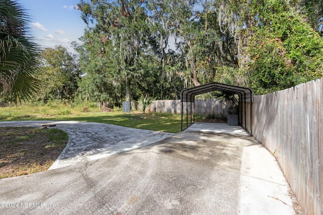 view of gate with a lawn