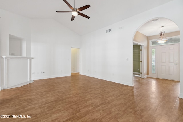 unfurnished living room featuring ceiling fan, wood-type flooring, and high vaulted ceiling