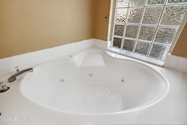 bathroom with a tub to relax in