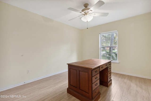 office with light hardwood / wood-style floors and ceiling fan