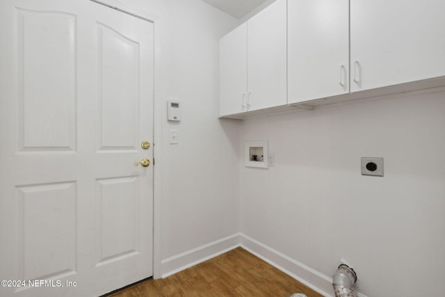 clothes washing area featuring cabinets, washer hookup, wood-type flooring, and hookup for an electric dryer