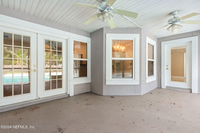 unfurnished sunroom featuring ceiling fan