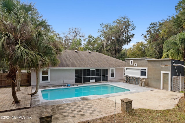 view of swimming pool with a patio and exterior kitchen