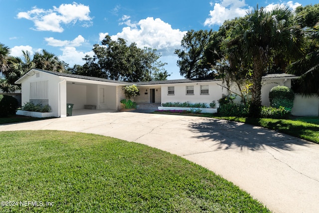 single story home featuring a carport and a front lawn