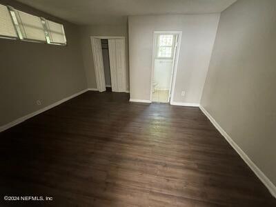 unfurnished room featuring dark hardwood / wood-style floors