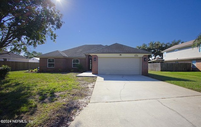 view of front of home with a garage and a front lawn