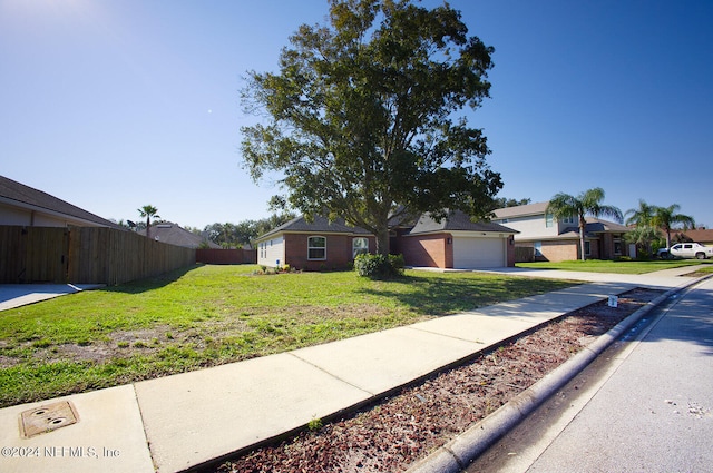 single story home with a front lawn and a garage