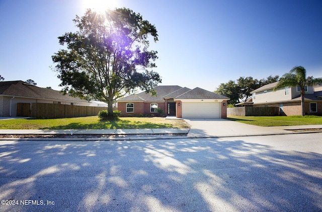 single story home with a garage and a front yard