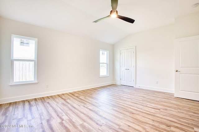 unfurnished room featuring ceiling fan, light hardwood / wood-style flooring, and vaulted ceiling