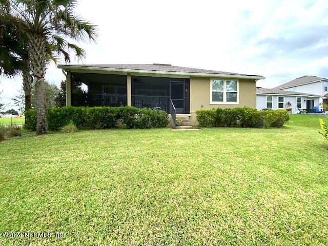 view of front of property with a front lawn and a sunroom