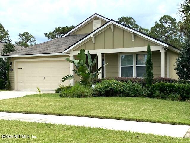 view of front of property with a front lawn and a garage