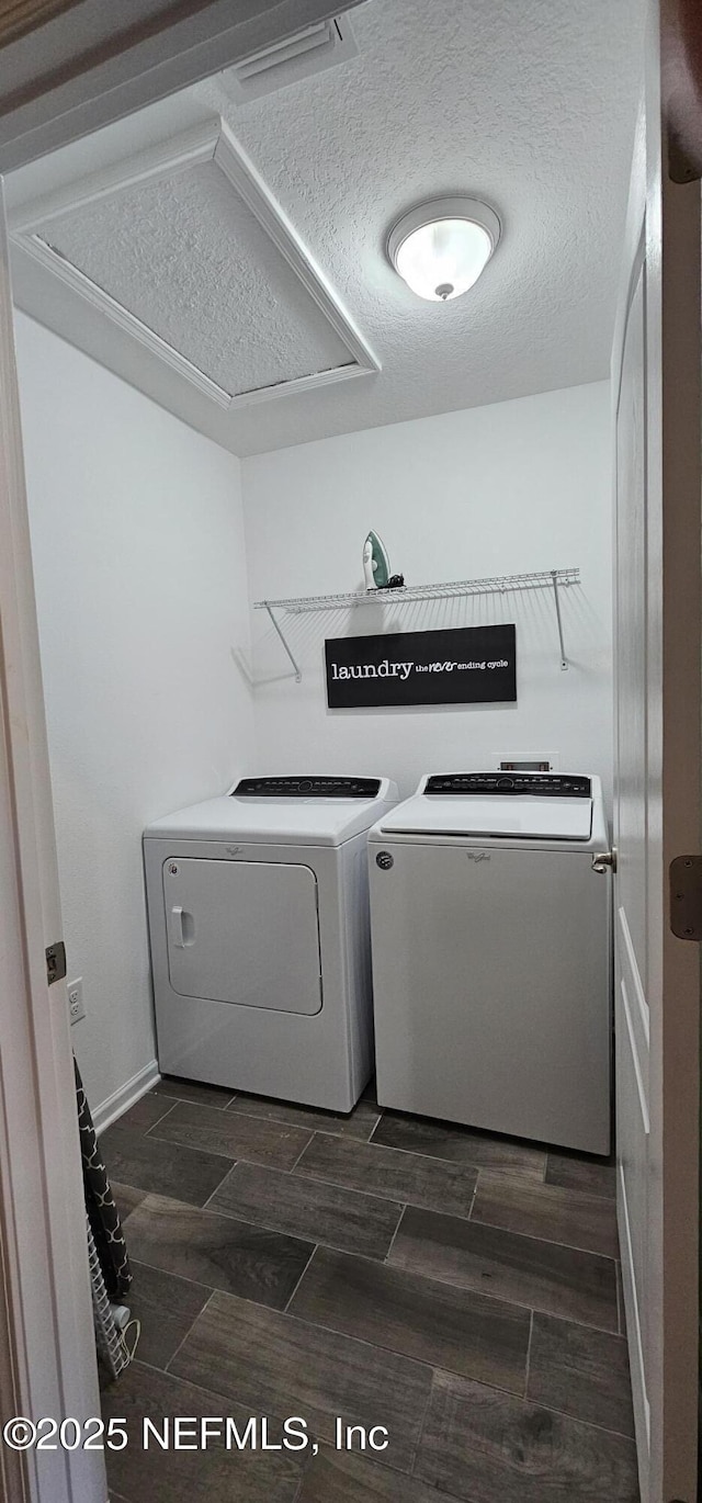 laundry area featuring washer and dryer and a textured ceiling