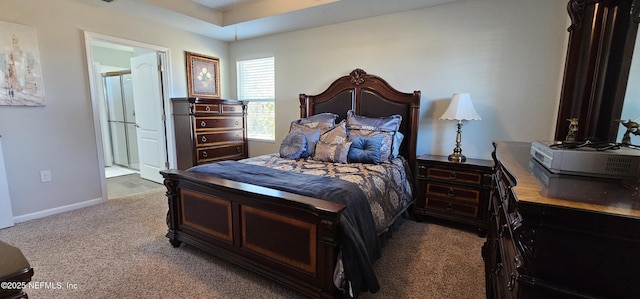 bedroom featuring ensuite bathroom and carpet flooring