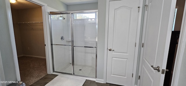 bathroom featuring a shower with shower door