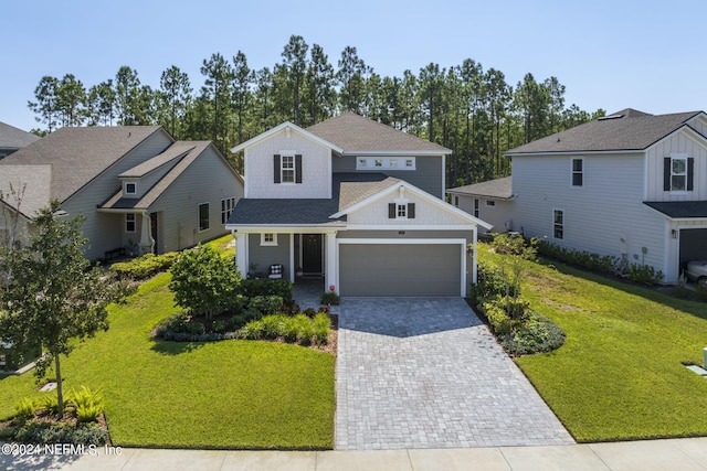 view of front of home featuring a front yard and a garage