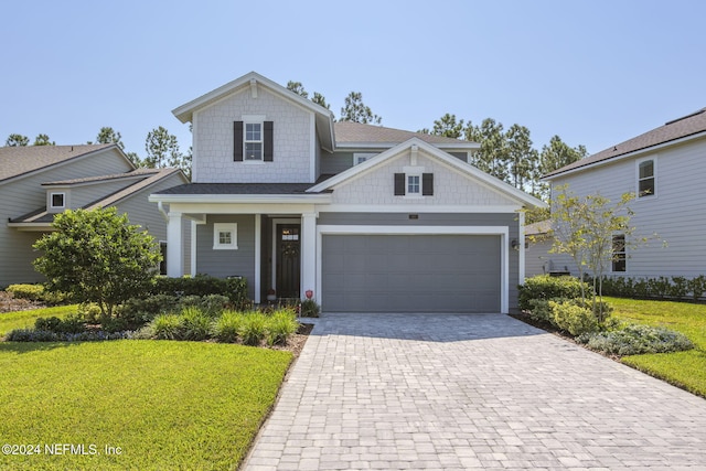 view of front of home with a garage and a front lawn