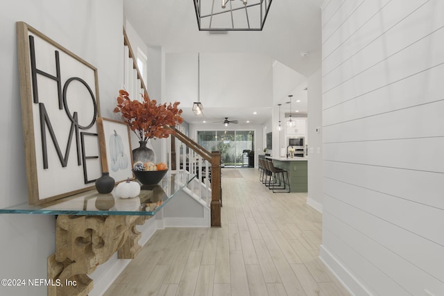 foyer featuring light wood-type flooring and ceiling fan