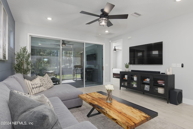 living room featuring light hardwood / wood-style floors and ceiling fan