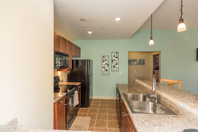 kitchen with sink, black appliances, and decorative light fixtures