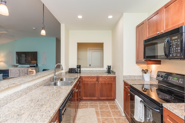 kitchen featuring light stone countertops, black appliances, sink, and hanging light fixtures