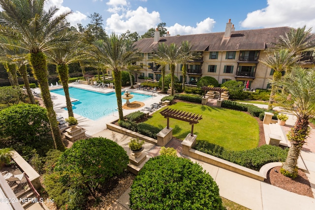 view of pool featuring a patio and a lawn