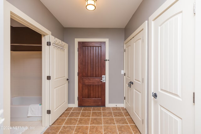 doorway featuring tile patterned flooring