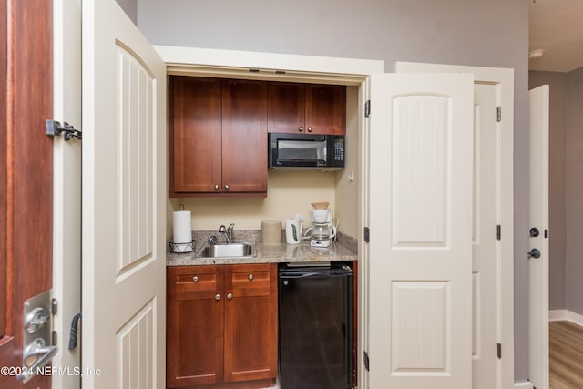 kitchen with black appliances, sink, and wood-type flooring