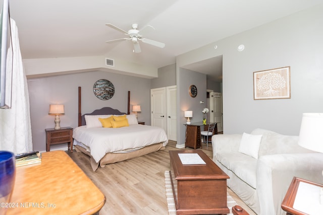 bedroom with light hardwood / wood-style floors, lofted ceiling, and ceiling fan