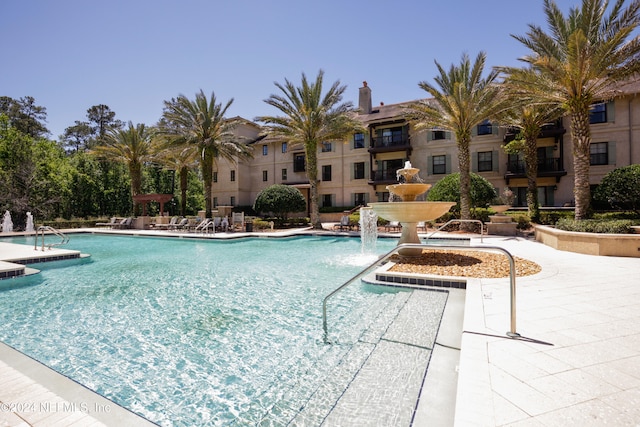 view of pool featuring pool water feature and a patio area