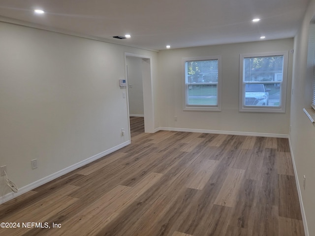 empty room with light hardwood / wood-style flooring