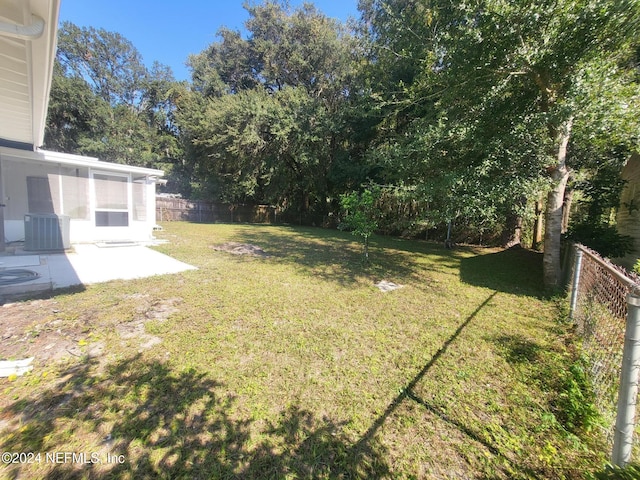 view of yard featuring central air condition unit and a patio