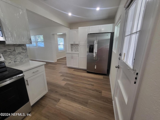 kitchen featuring white cabinetry, stainless steel appliances, and tasteful backsplash