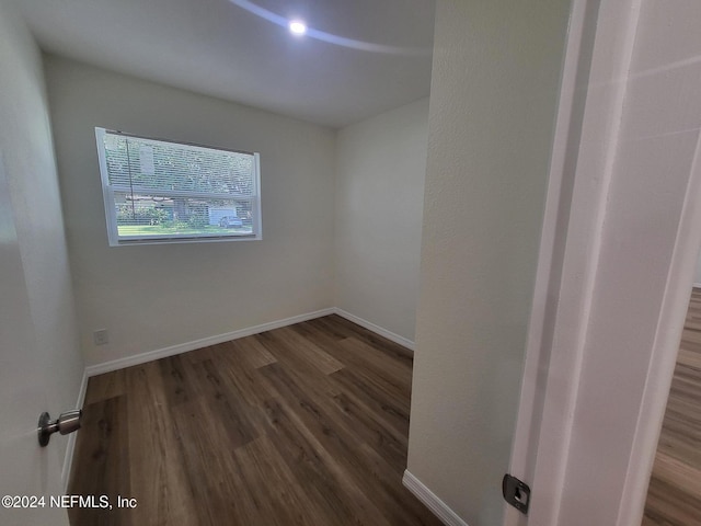 empty room featuring dark hardwood / wood-style flooring