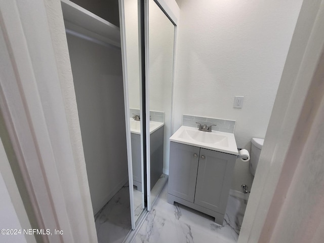 bathroom with vanity and toilet