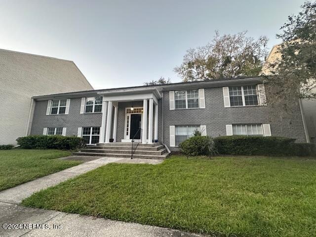 split foyer home with a front lawn