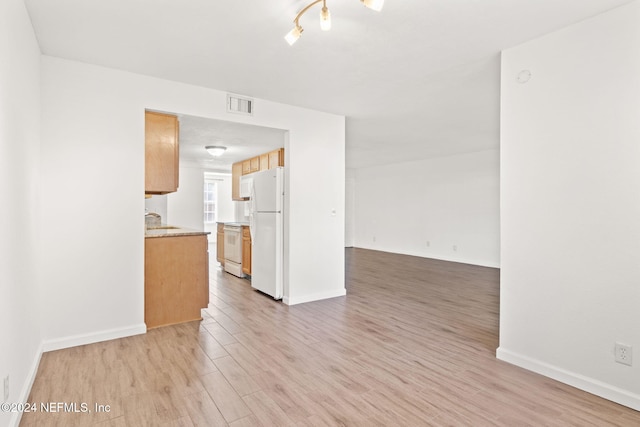 unfurnished living room featuring light hardwood / wood-style flooring and sink