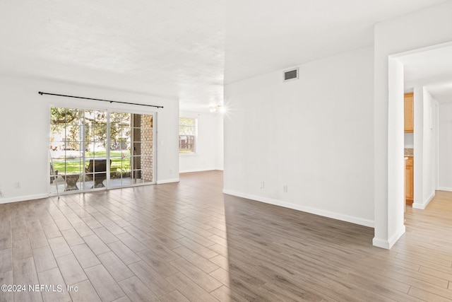 empty room with hardwood / wood-style floors