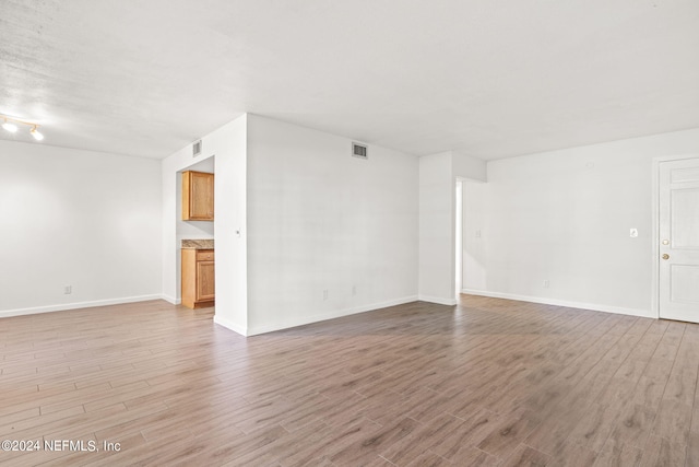 unfurnished living room with light hardwood / wood-style flooring