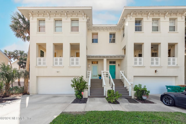 multi unit property featuring a balcony and a garage