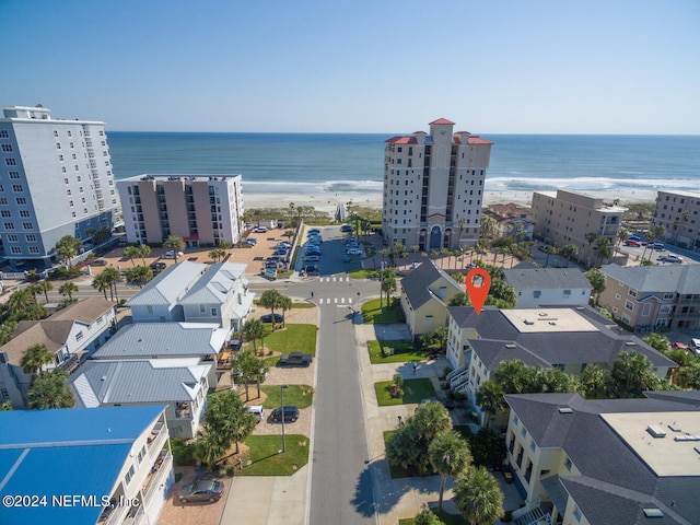 birds eye view of property with a beach view and a water view